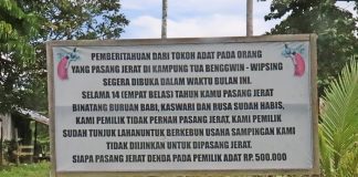 Plang Peraturan Kampung Larangan Berburu dan Pasang jerat di Kampung Benguin Progo, foto : nesta/jeratpapua.org